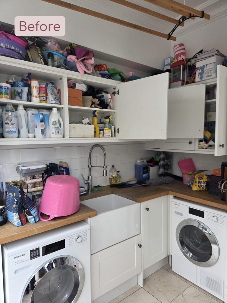 a utility room with lots of disorganised items in the cupboards and on the counters
